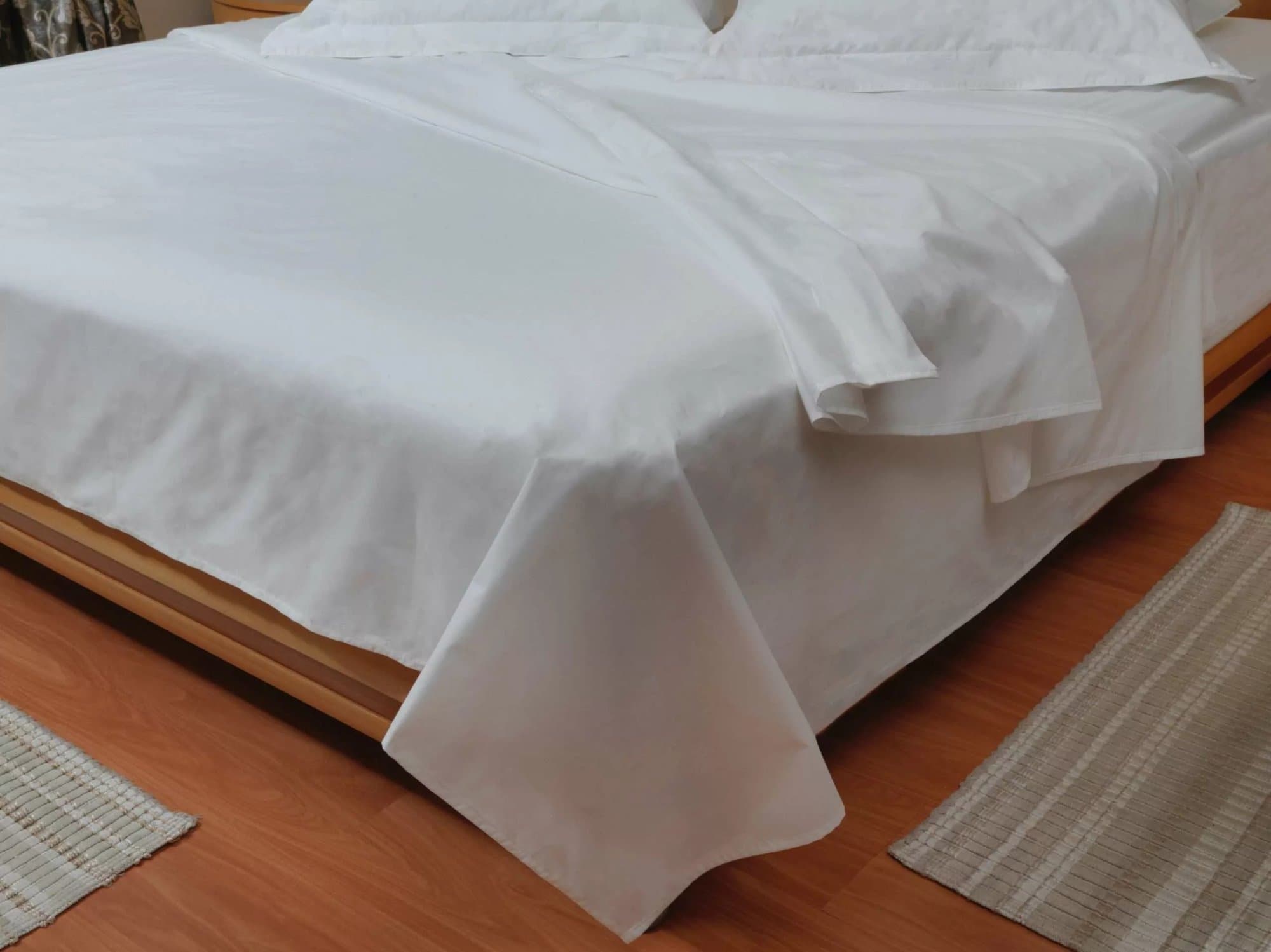 Bed made up with a white cotton percale sheet set, from the C4G linen range quoted in USD for Zimbabwe